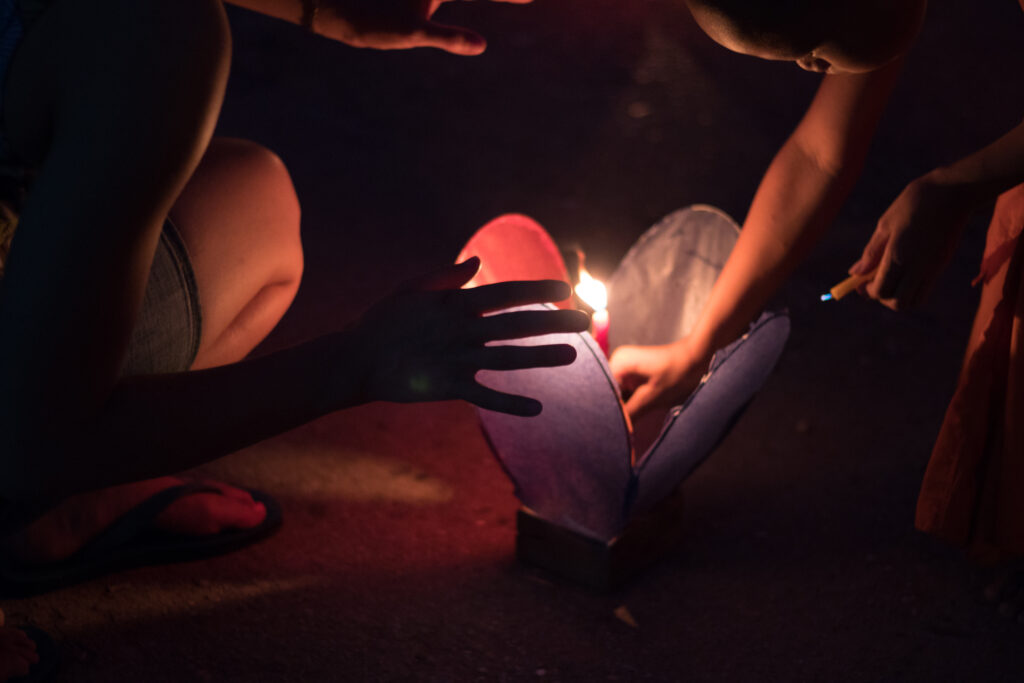 Monk and tourist light lantern